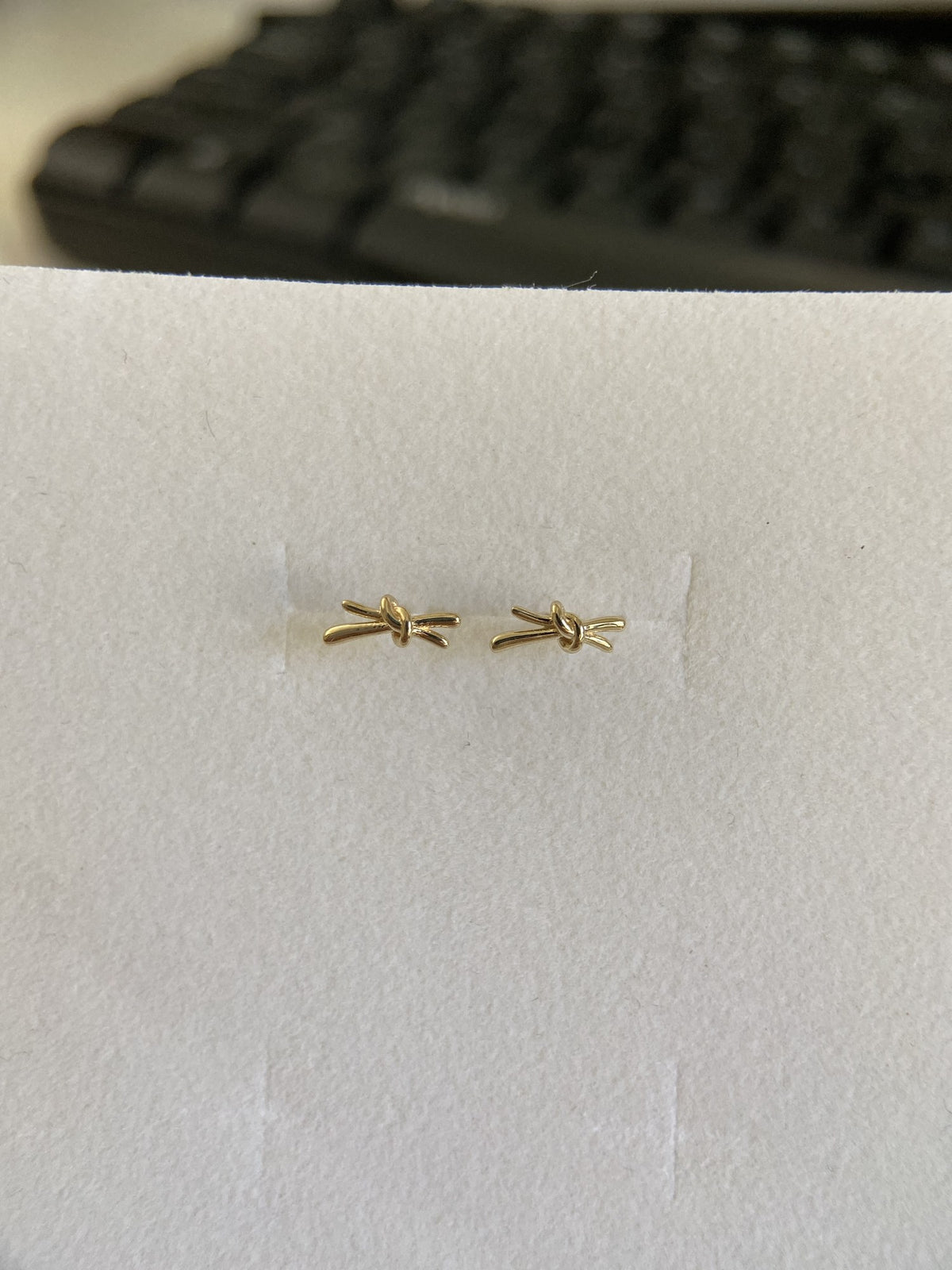 Actual product photo of 14K Solid Gold Ribbon Knot Stud Earrings, reference view 1