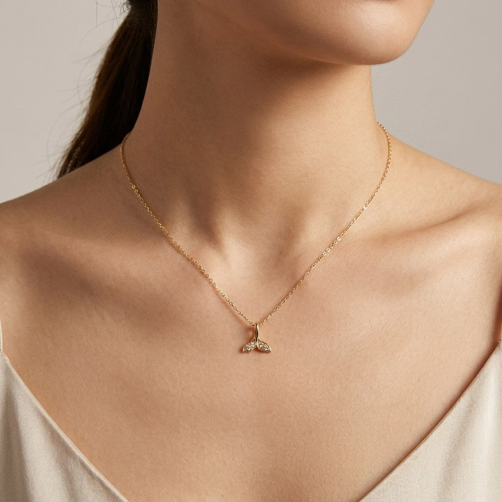 14K solid gold double leaf pendant worn on a fine chain