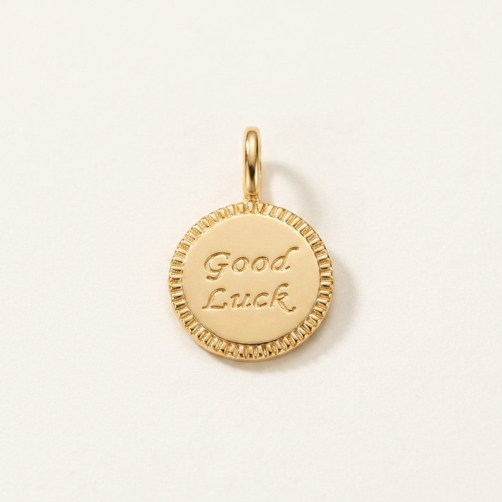 14K solid gold good luck coin pendant on a warm ivory background