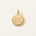 14K solid gold good luck coin pendant on a warm ivory background