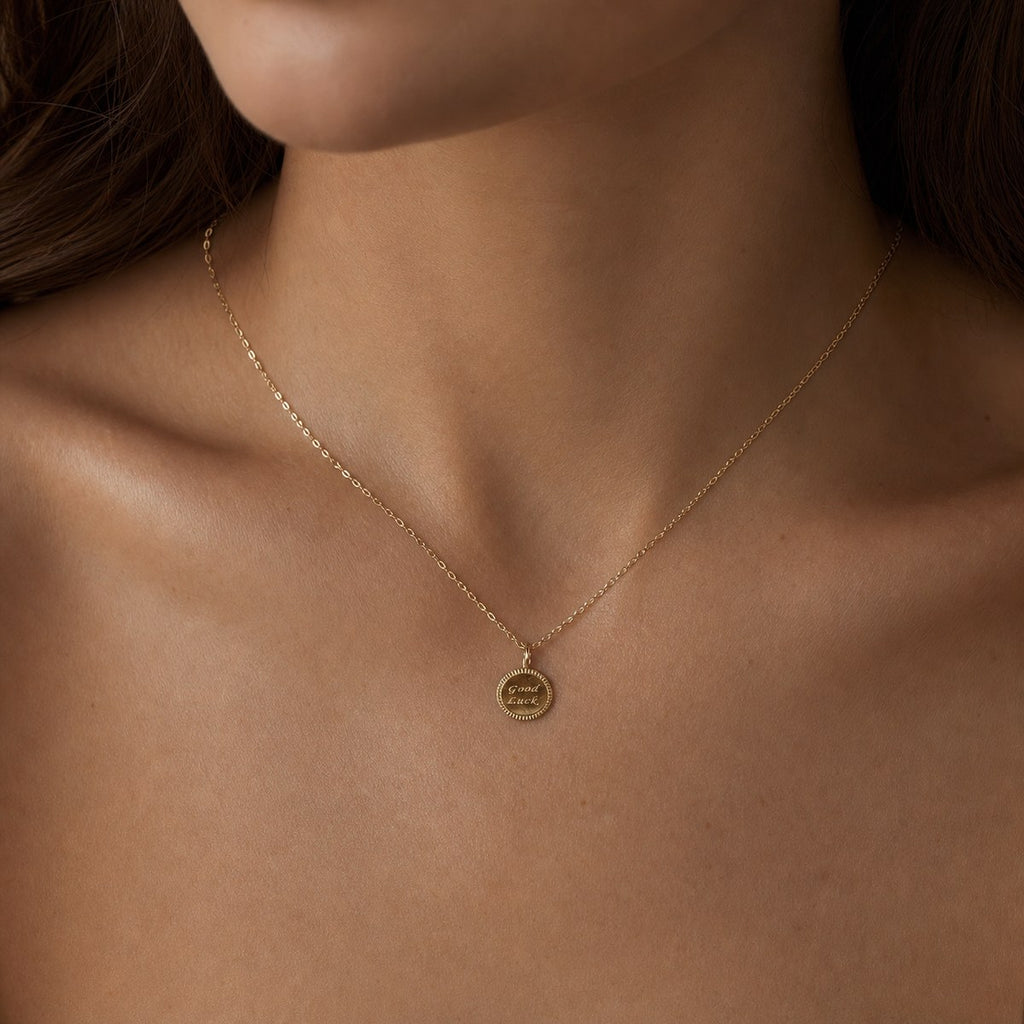 14K solid gold good luck coin pendant worn on a fine chain