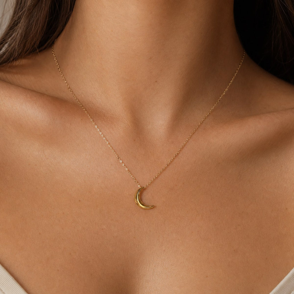 14K solid gold sculpted crescent moon pendant worn on a fine chain