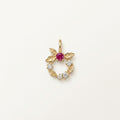 14K solid gold floral wreath pendant on a warm ivory background