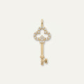 14K solid gold pavé clover key pendant on a warm ivory background
