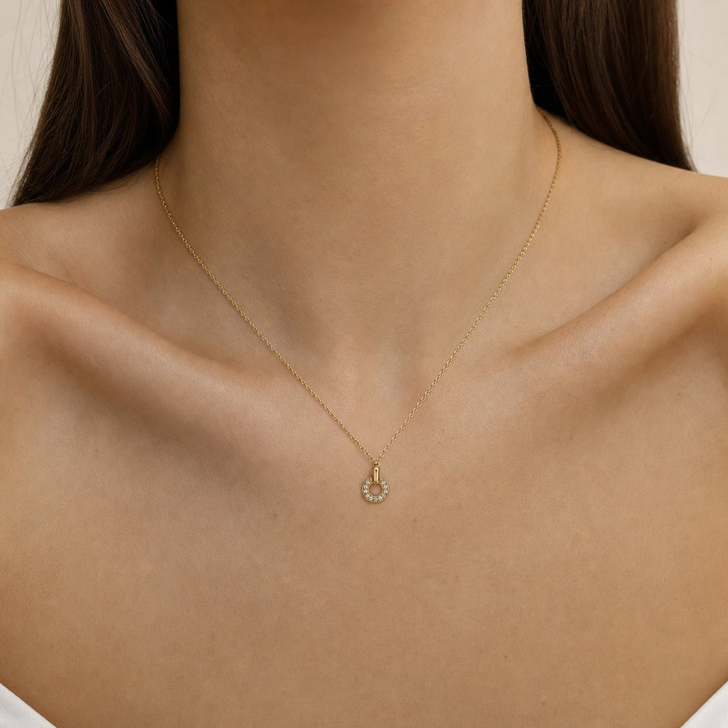 14K solid gold pavé horseshoe pendant worn on a fine chain
