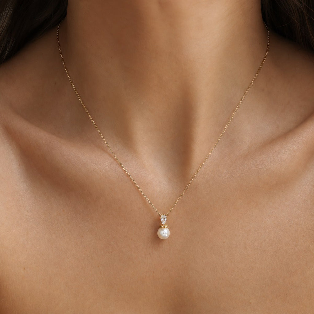 14K solid gold pearlescent drop pendant worn on a fine chain