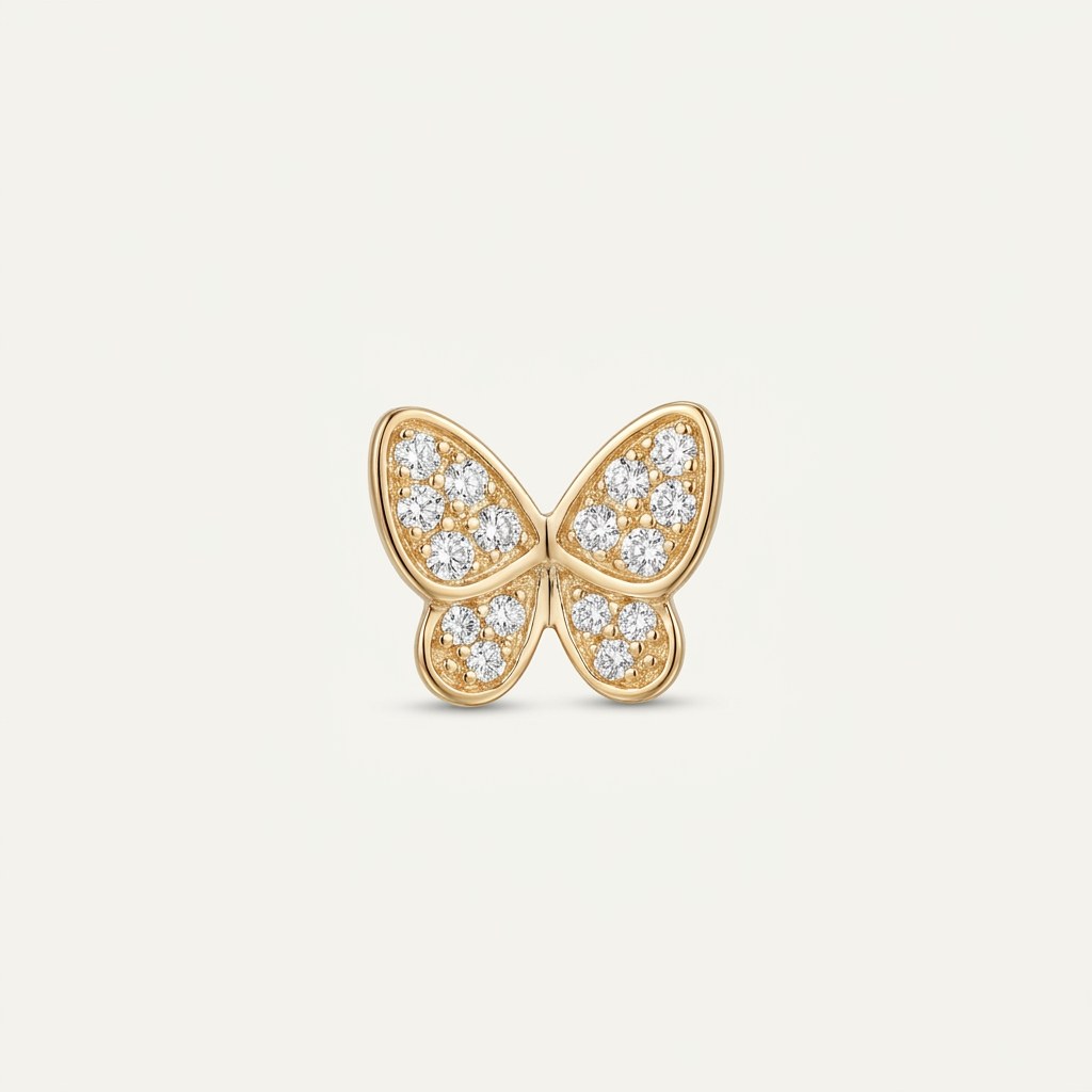 14K solid gold pavé butterfly pendant on a warm ivory background