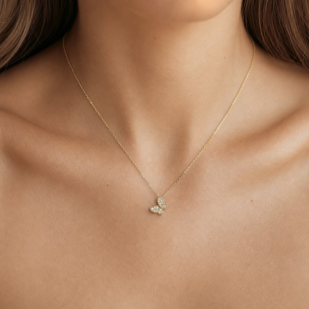 14K solid gold pavé butterfly pendant worn on a fine chain