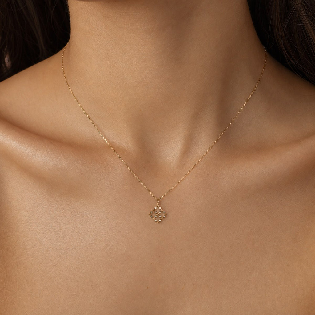 14K solid gold geometric lattice pendant worn on a fine chain