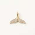 14K solid gold pavé whale tail pendant on a warm ivory background