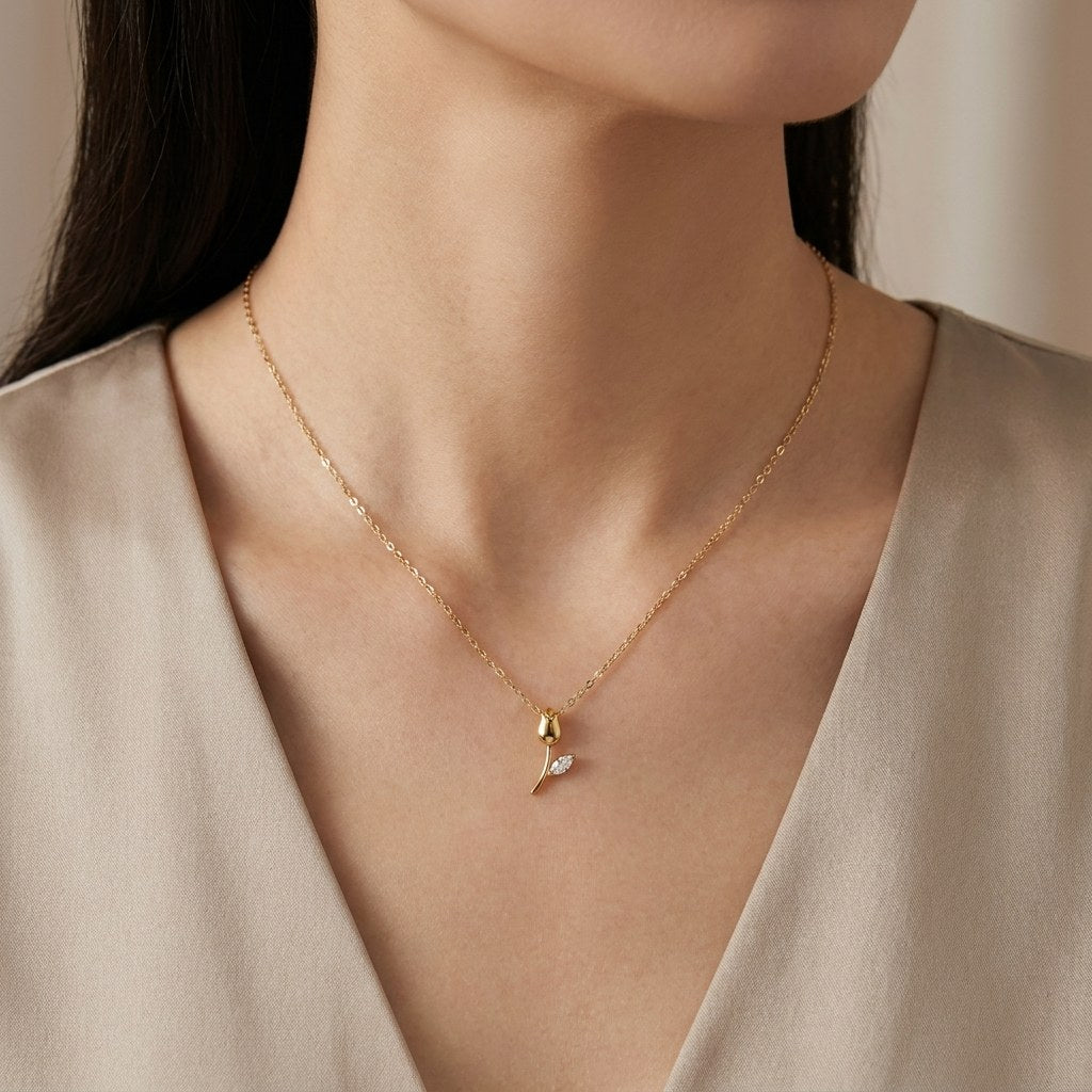 14K solid gold rosebud pendant worn on a fine chain