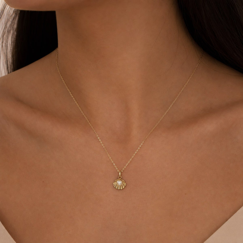 14K solid gold pearl scallop shell pendant worn on a fine chain