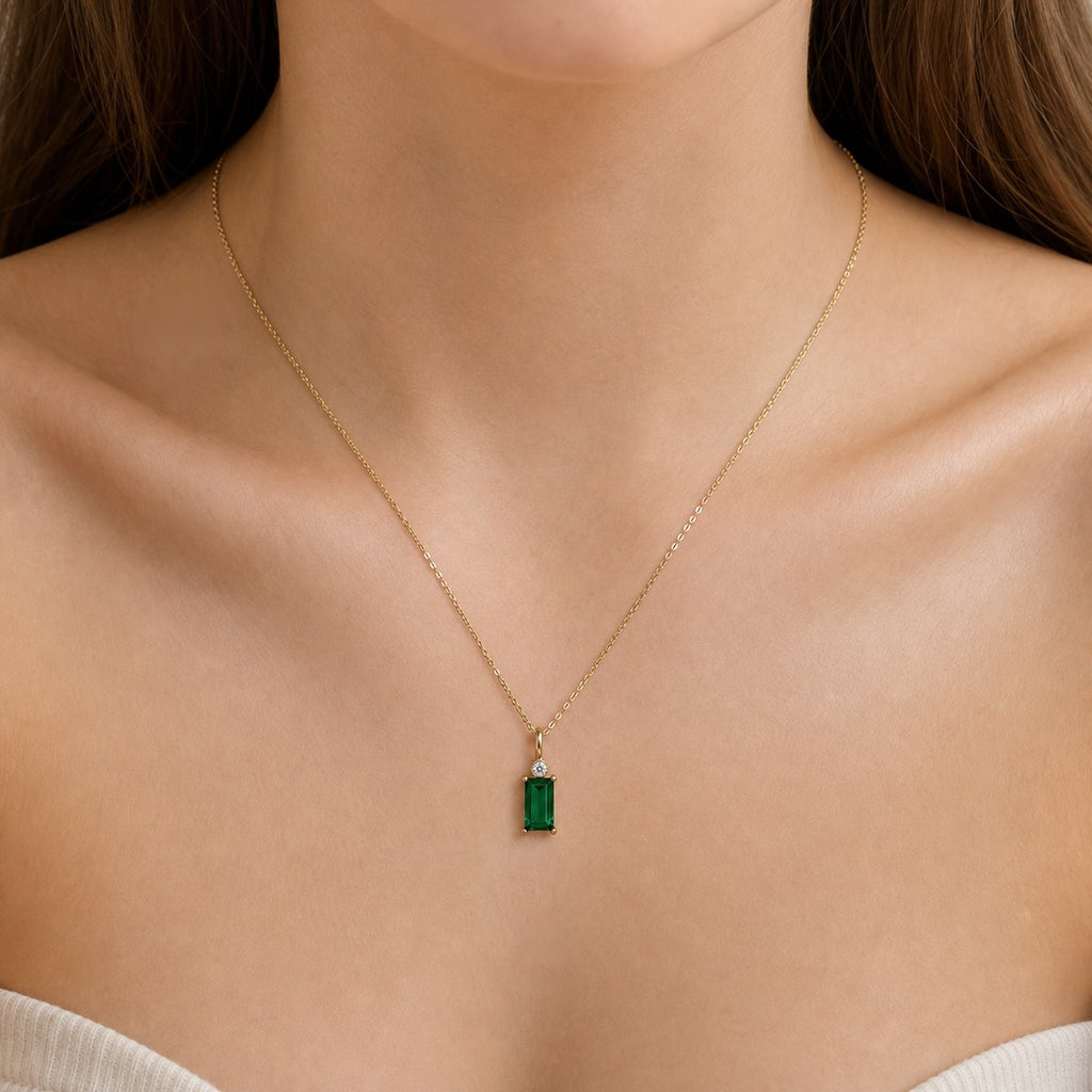 14K solid gold green rectangular stone pendant worn on a fine chain