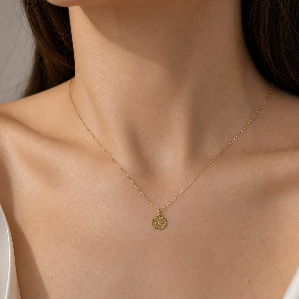 14K solid gold rose coin pendant worn on a fine chain