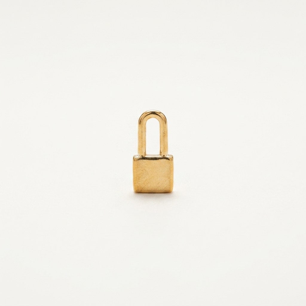 14K solid gold padlock pendant on a warm ivory background