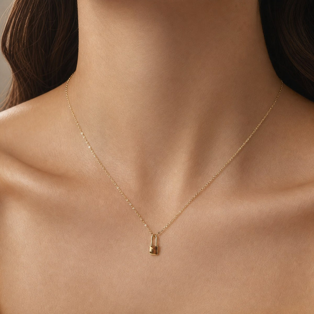 14K solid gold padlock pendant worn on a fine chain