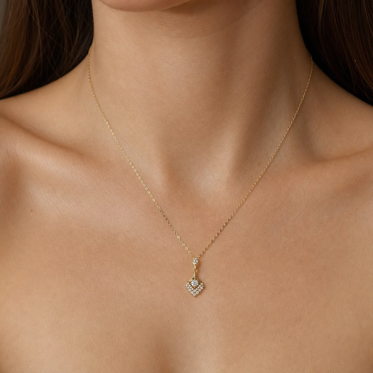 14K solid gold ornate kite pendant worn on a fine chain