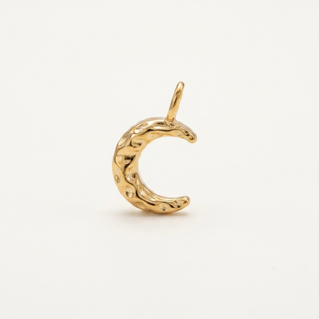 14K solid gold textured crescent moon pendant on a warm ivory background