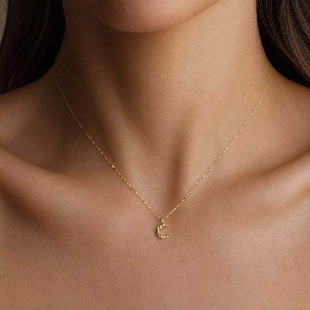 14K solid gold textured crescent moon pendant worn on a fine chain