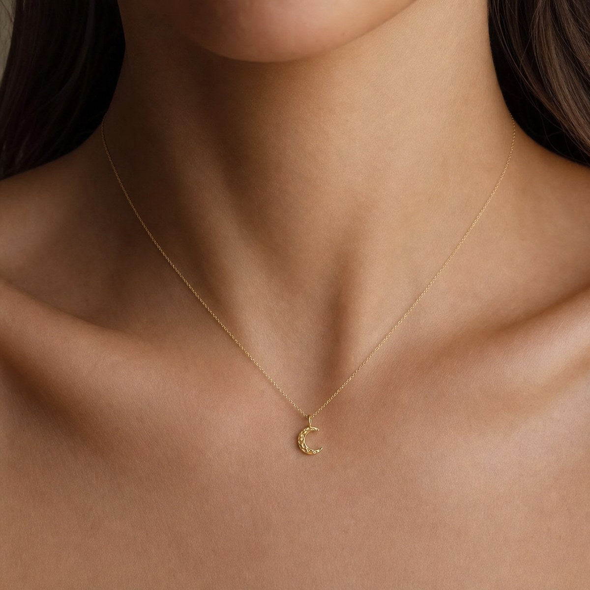 14K solid gold textured crescent moon pendant worn on a fine chain