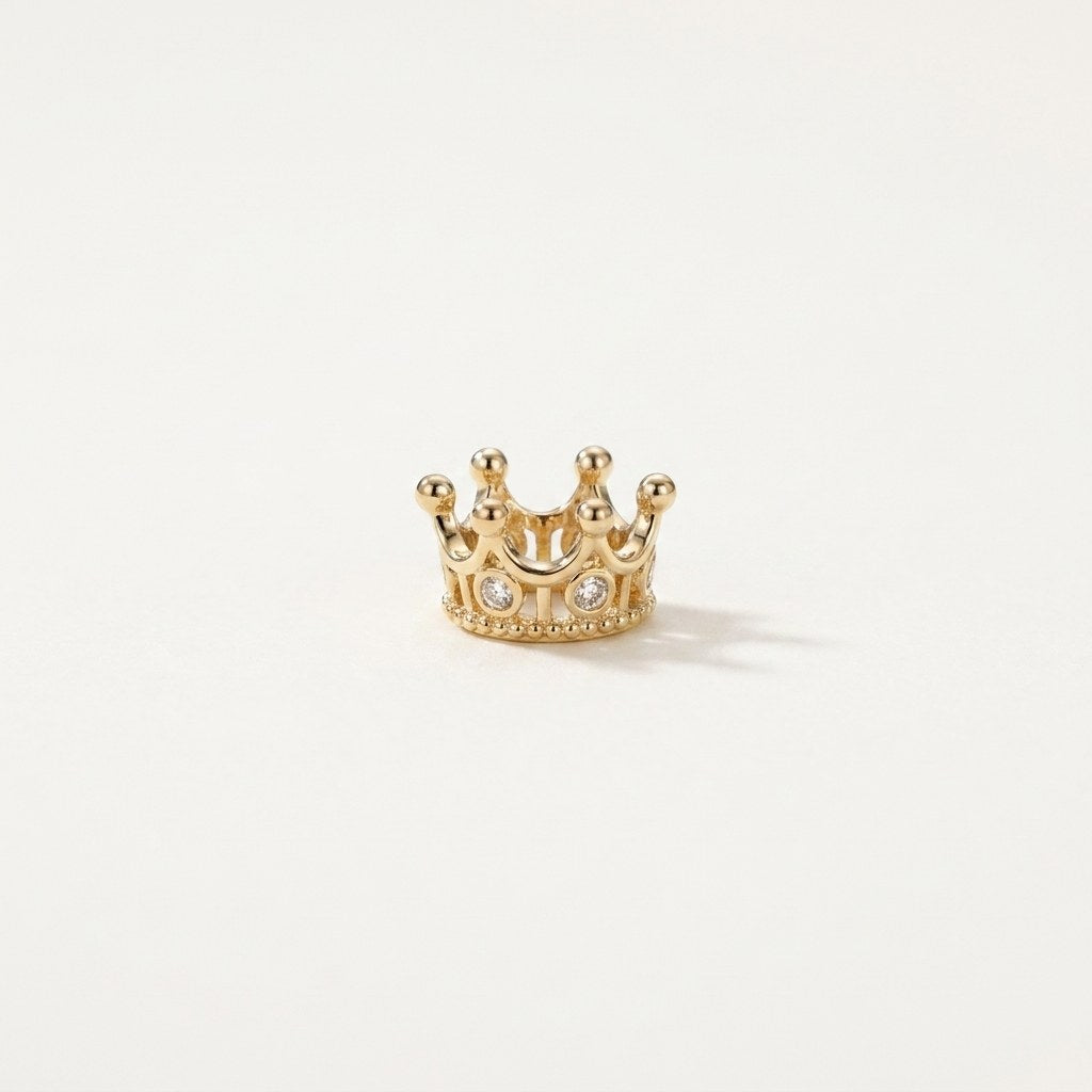 14K solid gold moissanite crown pendant on a warm ivory background