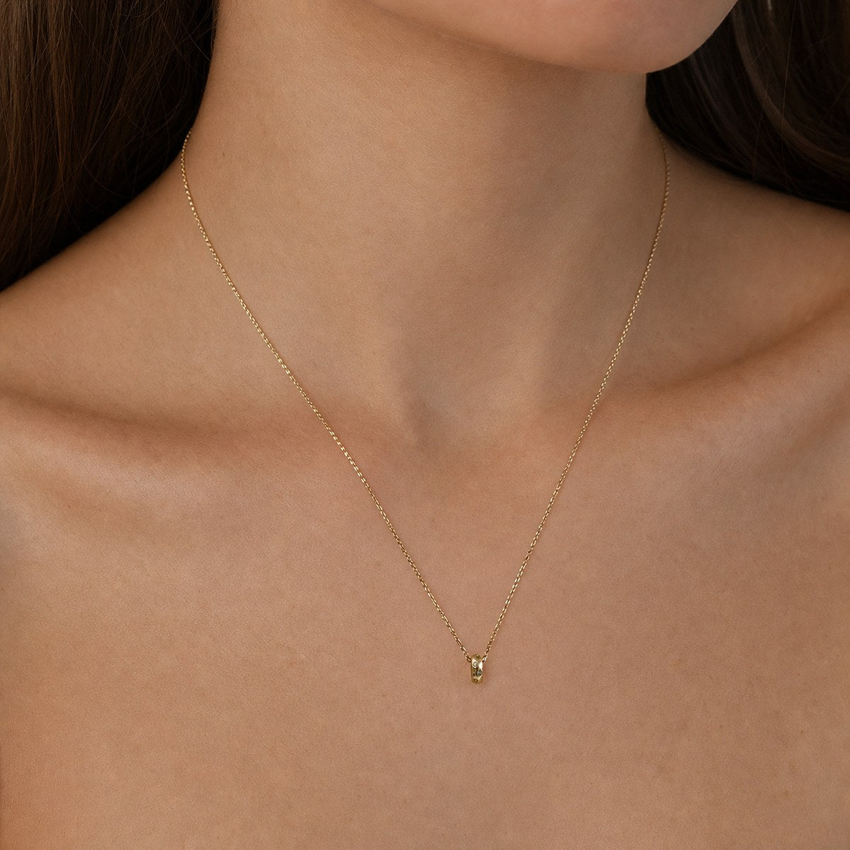 14K solid gold moissanite oval ring pendant worn on a fine chain