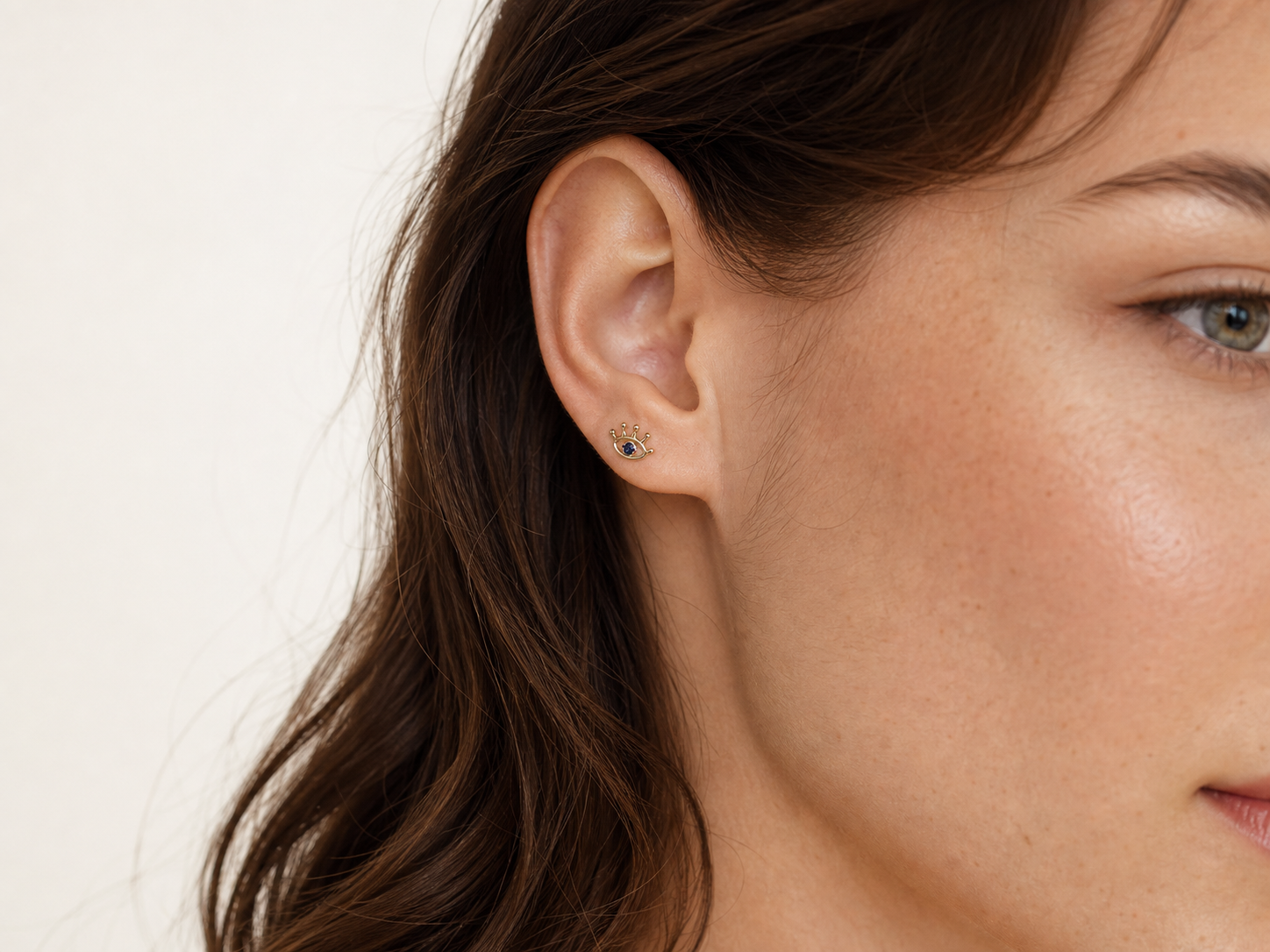 Solid gold eye stud earring worn on ear, product 402