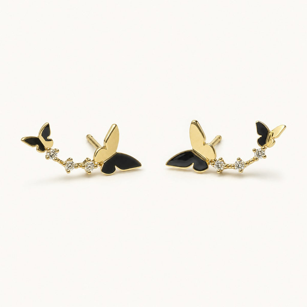 14K solid gold butterfly floral climber stud earrings on a warm ivory background