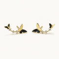 14K solid gold butterfly floral climber stud earrings on a warm ivory background