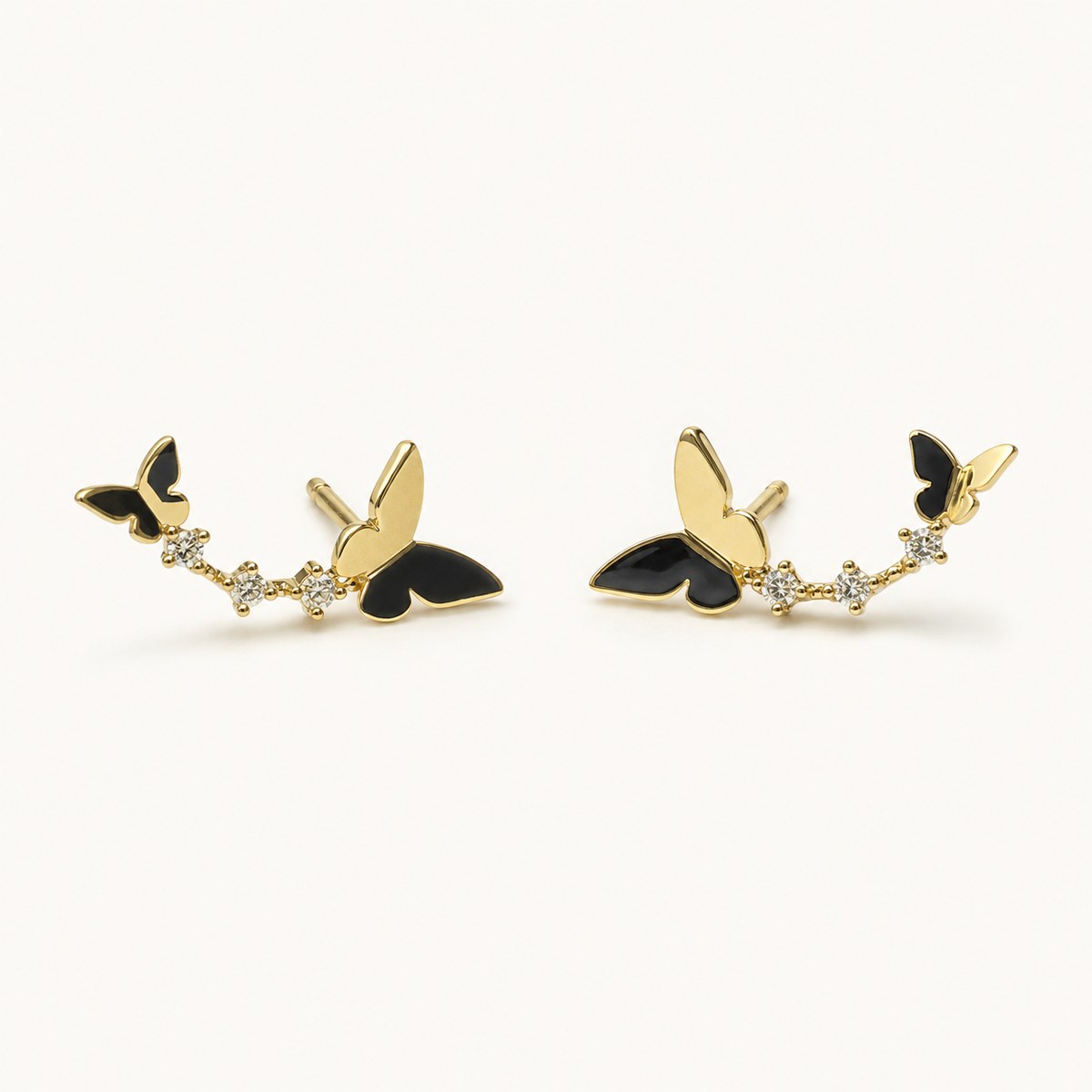 14K solid gold butterfly floral climber stud earrings on a warm ivory background