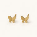 14K solid gold polished butterfly stud earrings on a warm ivory background