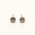14K solid gold classic round solitaire stud earrings on a warm ivory background