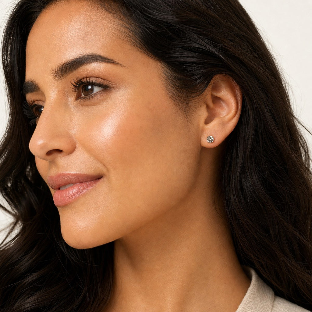 14K solid gold classic round solitaire stud earrings worn on an ear