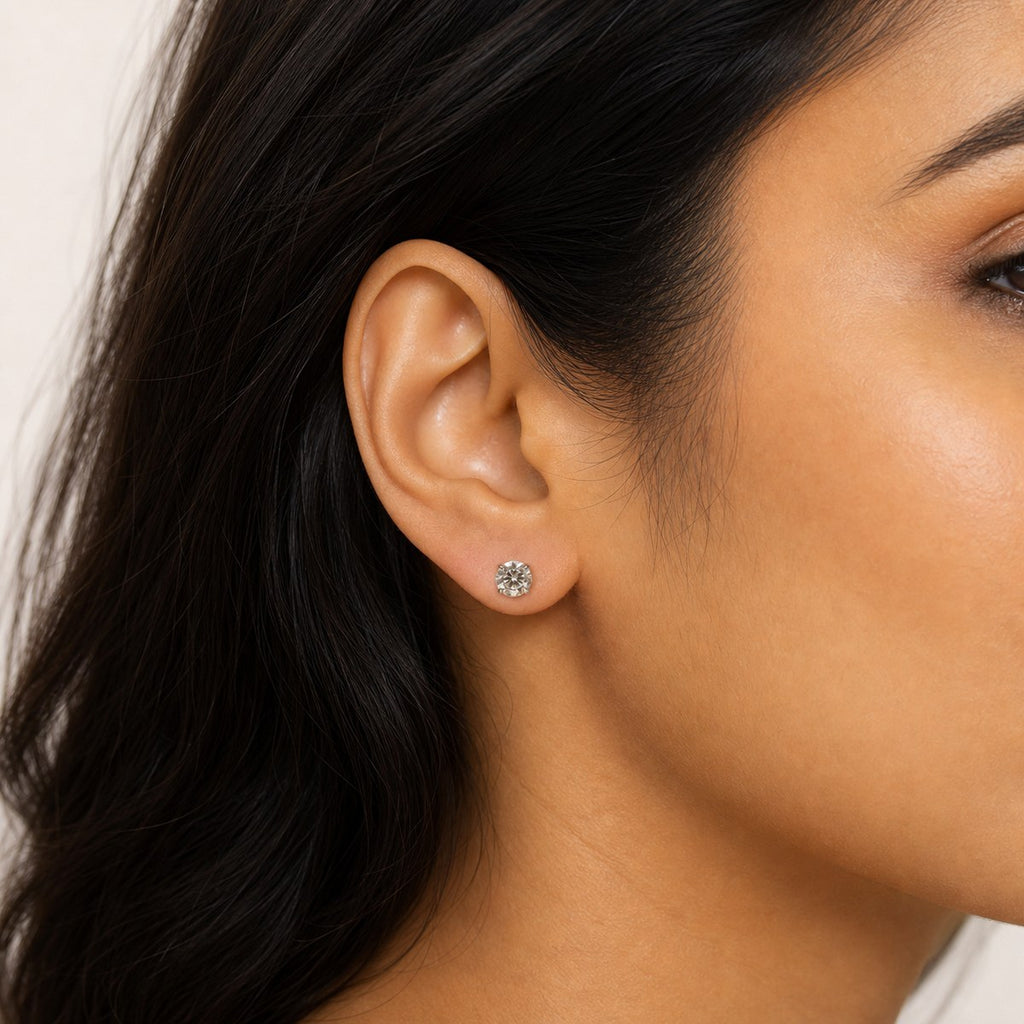 14K solid gold large round solitaire stud earrings worn on an ear