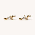 14K solid gold crystal leaf branch stud earrings on a warm ivory background