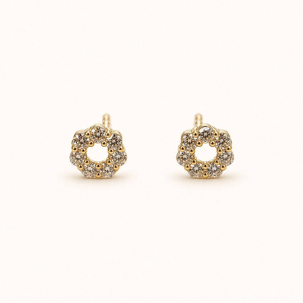 14K solid gold floral halo stud earrings on a warm ivory background