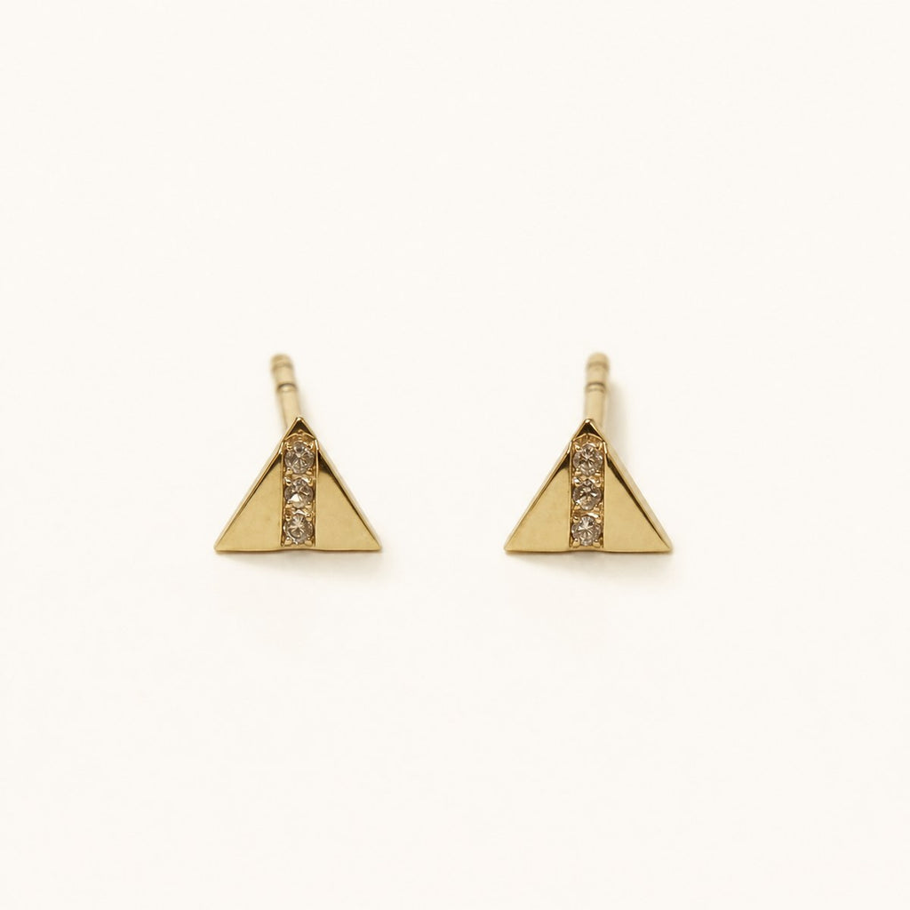 14K solid gold geometric triangle stud earrings on a warm ivory background