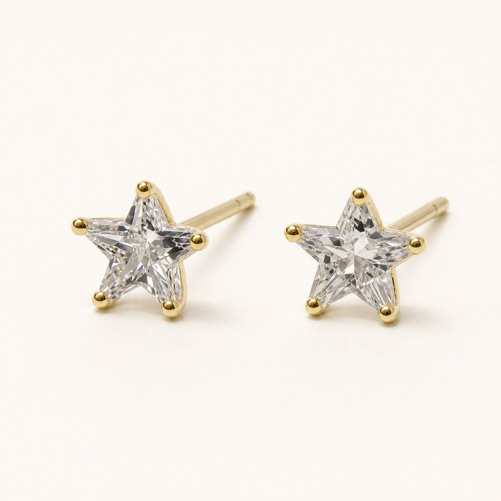 14K solid gold crystal star stud earrings on a warm ivory background