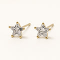 14K solid gold crystal star stud earrings on a warm ivory background