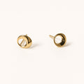 14K solid gold open circle stud earrings on a warm ivory background