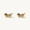 14K solid gold crystal bow stud earrings on a warm ivory background