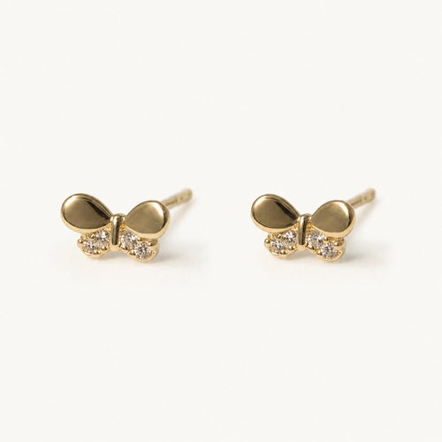 14K solid gold crystal bow stud earrings on a warm ivory background