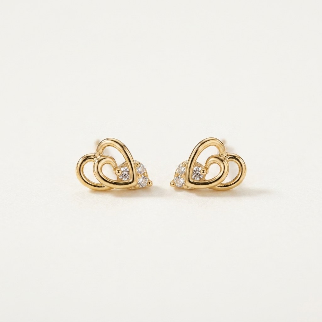 14K solid gold double heart stud earrings on a warm ivory background