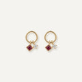 14K solid gold ruby circle drop stud earrings on a warm ivory background