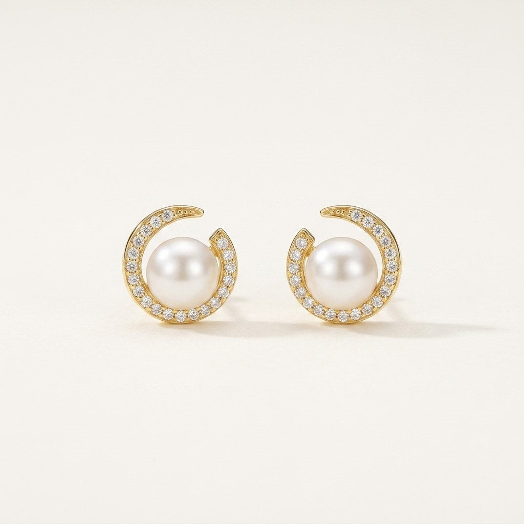 14K solid gold pearl crescent stud earrings on a warm ivory background