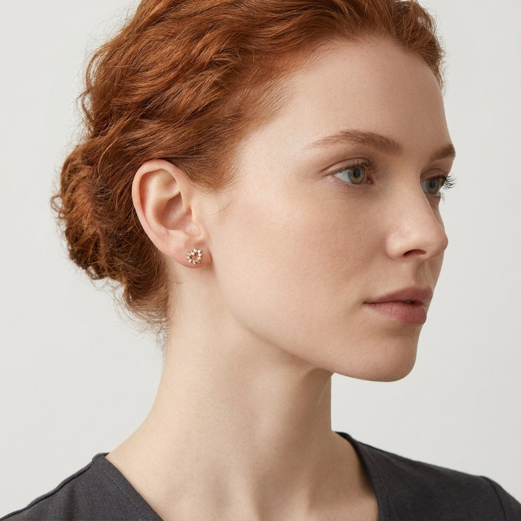 14K solid gold floral sprig stud earrings worn on an ear