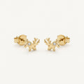 14K solid gold petite antler stud earrings on a warm ivory background