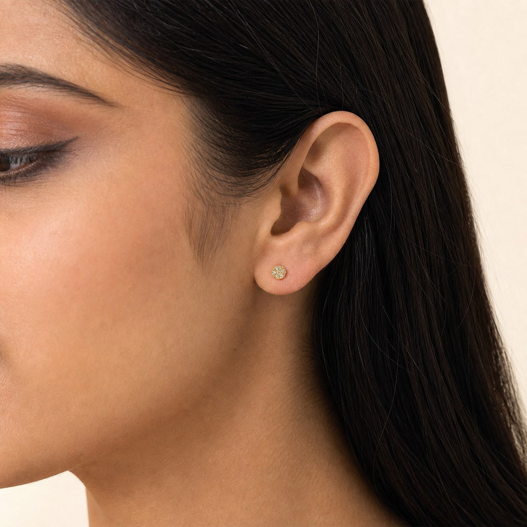 14K solid gold round crystal halo stud earrings worn on an ear