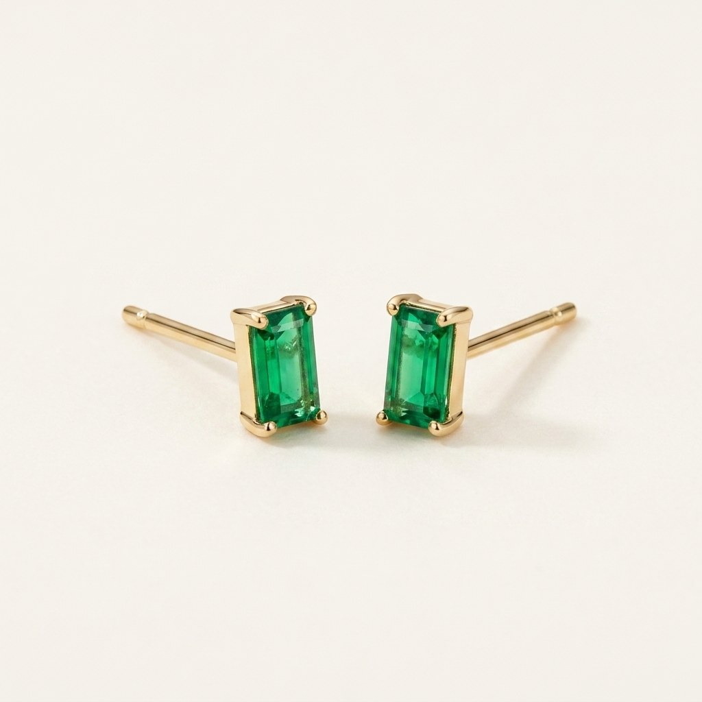 14K solid gold green emerald cut stud earrings on a warm ivory background