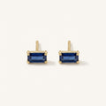 14K solid gold blue emerald cut stud earrings on a warm ivory background